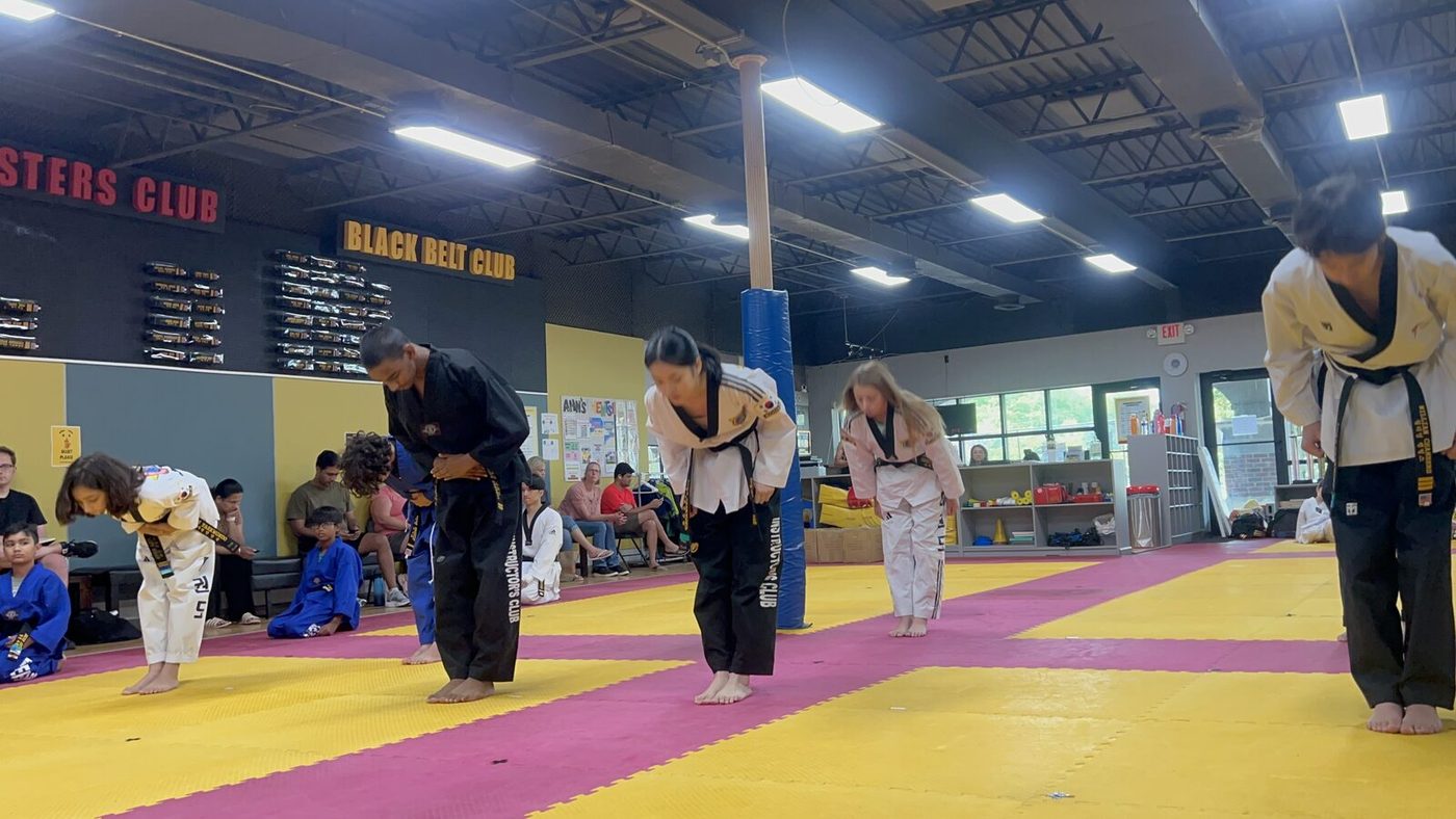 Black belt students bowing at the end of the August 2026 Belt Test