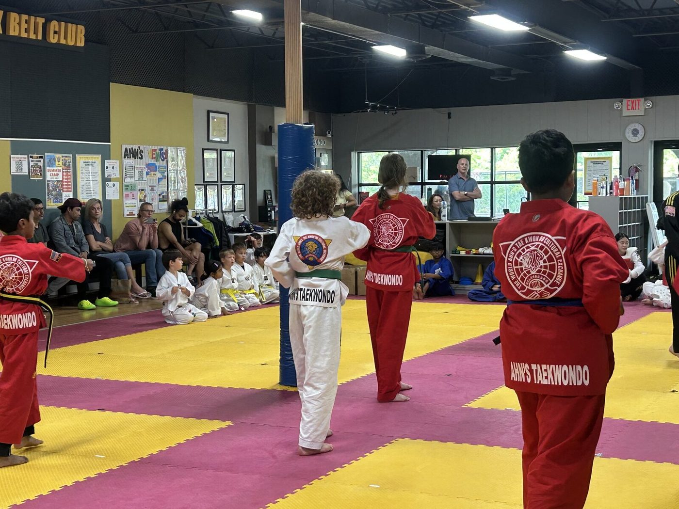 Ahn's Taekwondo demo team students in red uniforms during the belt test