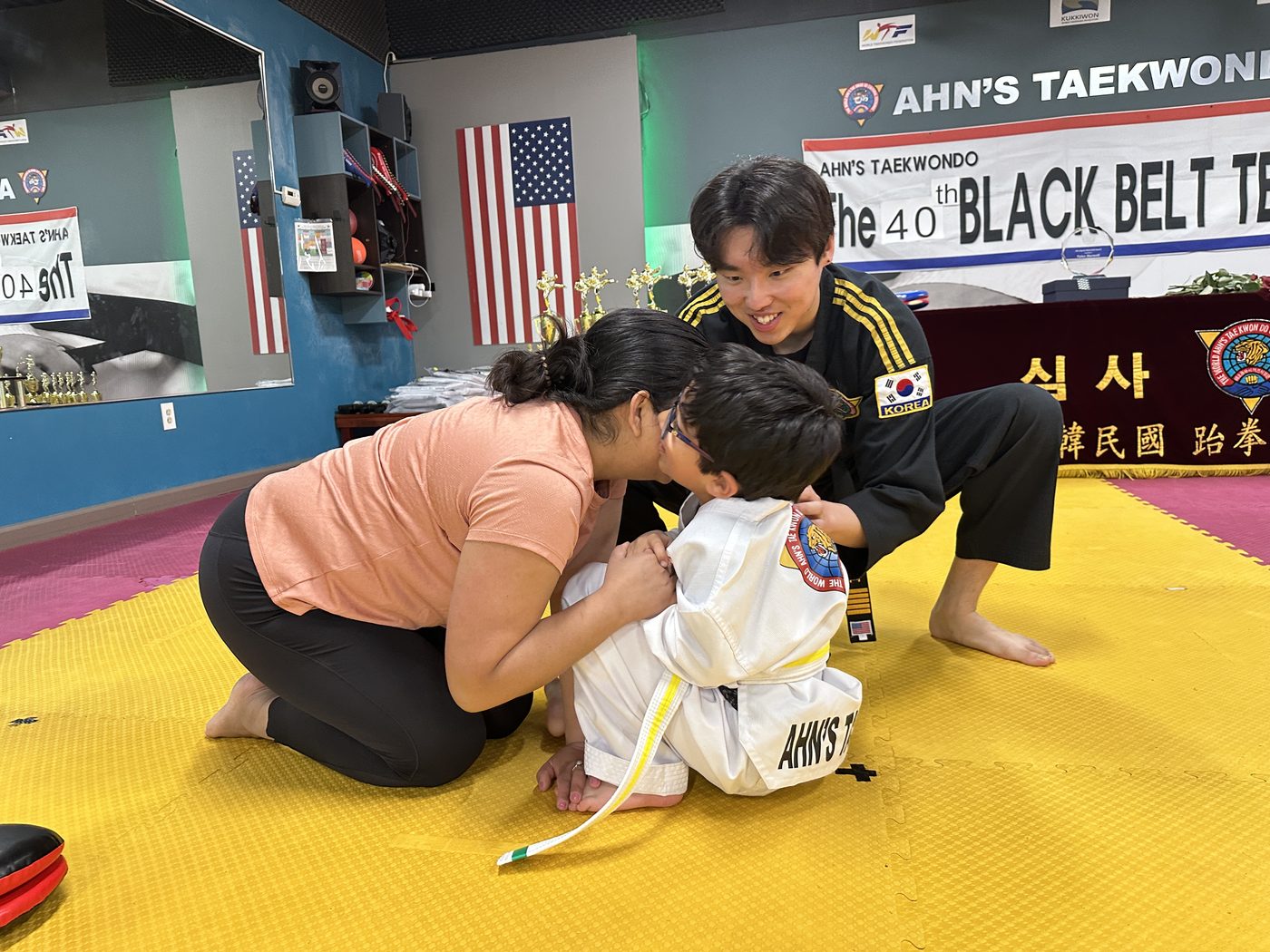 Family celebrating a student at Ahn's Taekwondo Black Belt Test