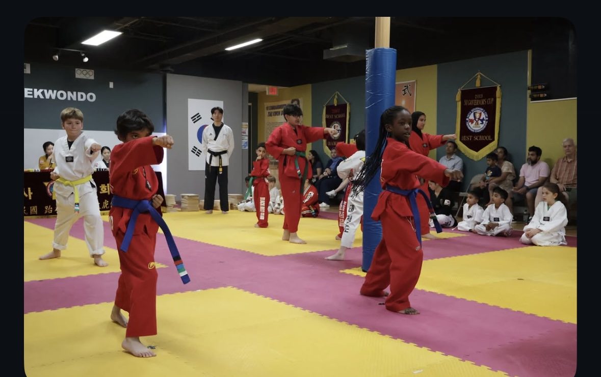 Kids martial arts class practicing basic stances at Ahn's Taekwondo