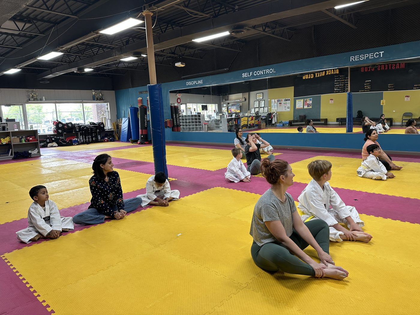 Families stretching together during Parent & Cub class
