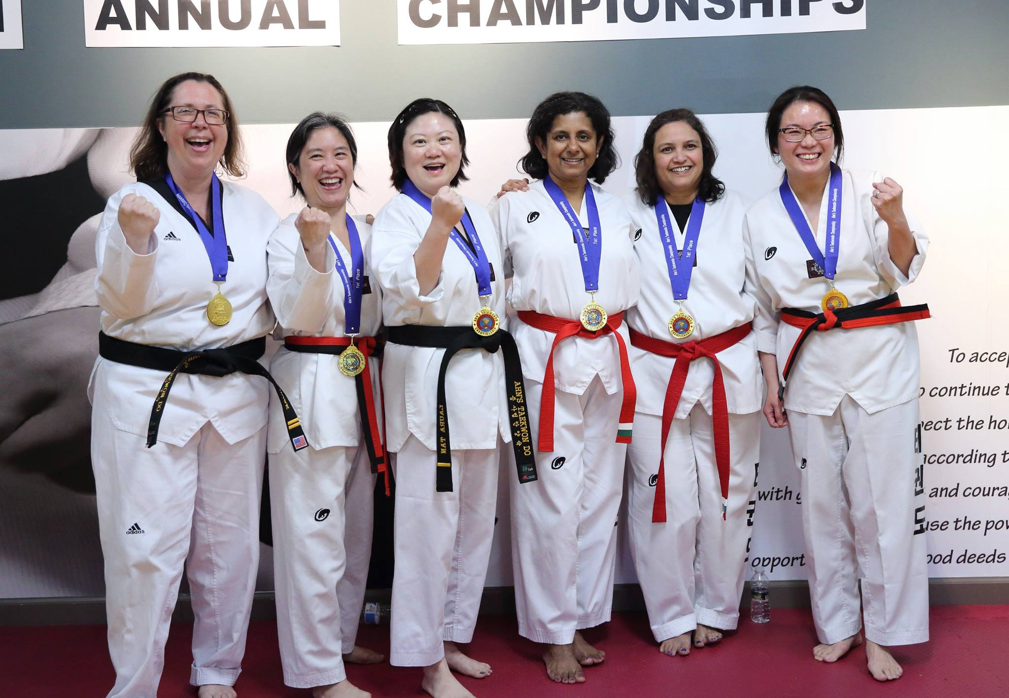 Ahn's Taekwondo team celebrating their championship medals