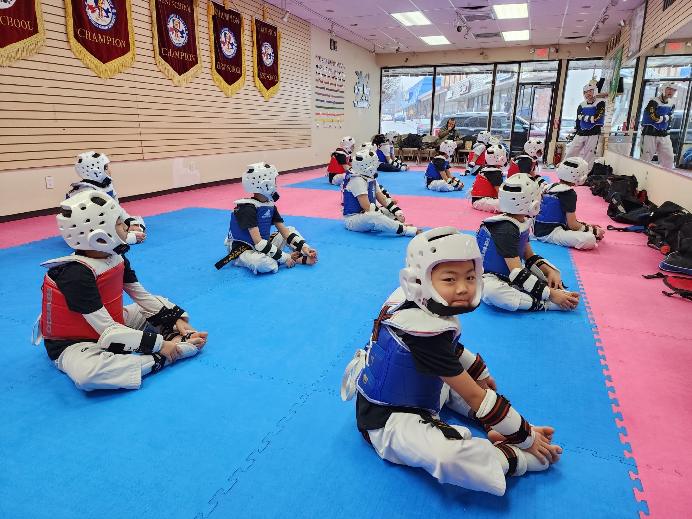 Kids in sparring gear during class