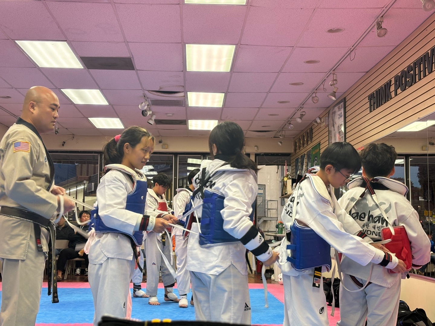 Instructor helping students at Dae Han Taekwondo