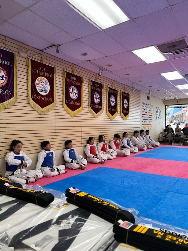 Students in sparring gear at the dojang