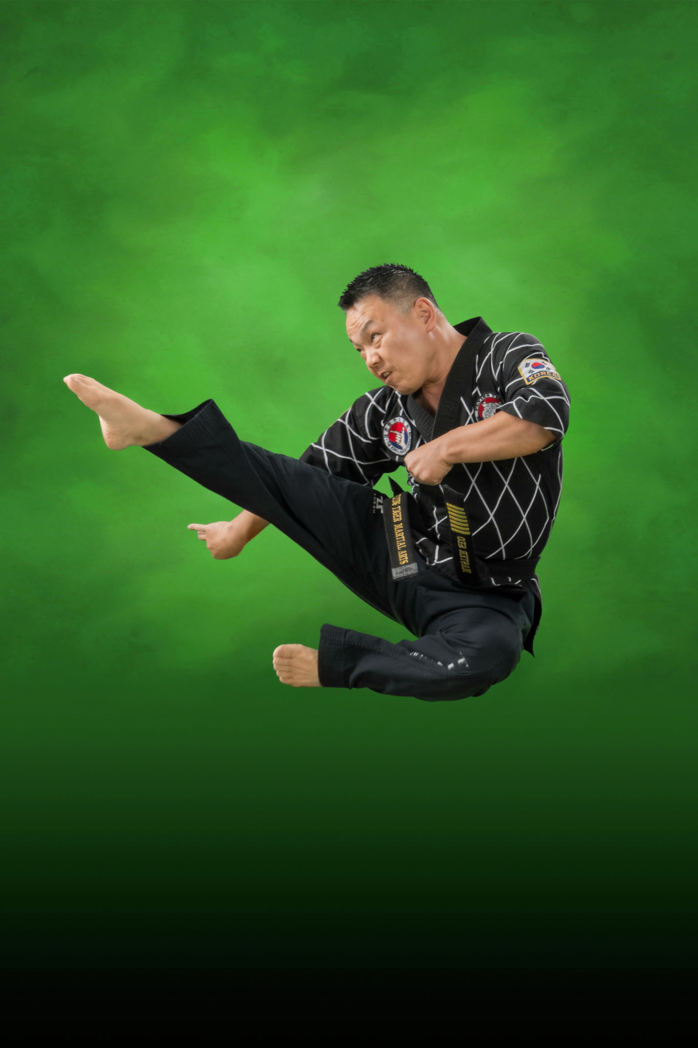 Master Seo demonstrating a flying kick at Flying Tiger Martial Arts in Garner, NC