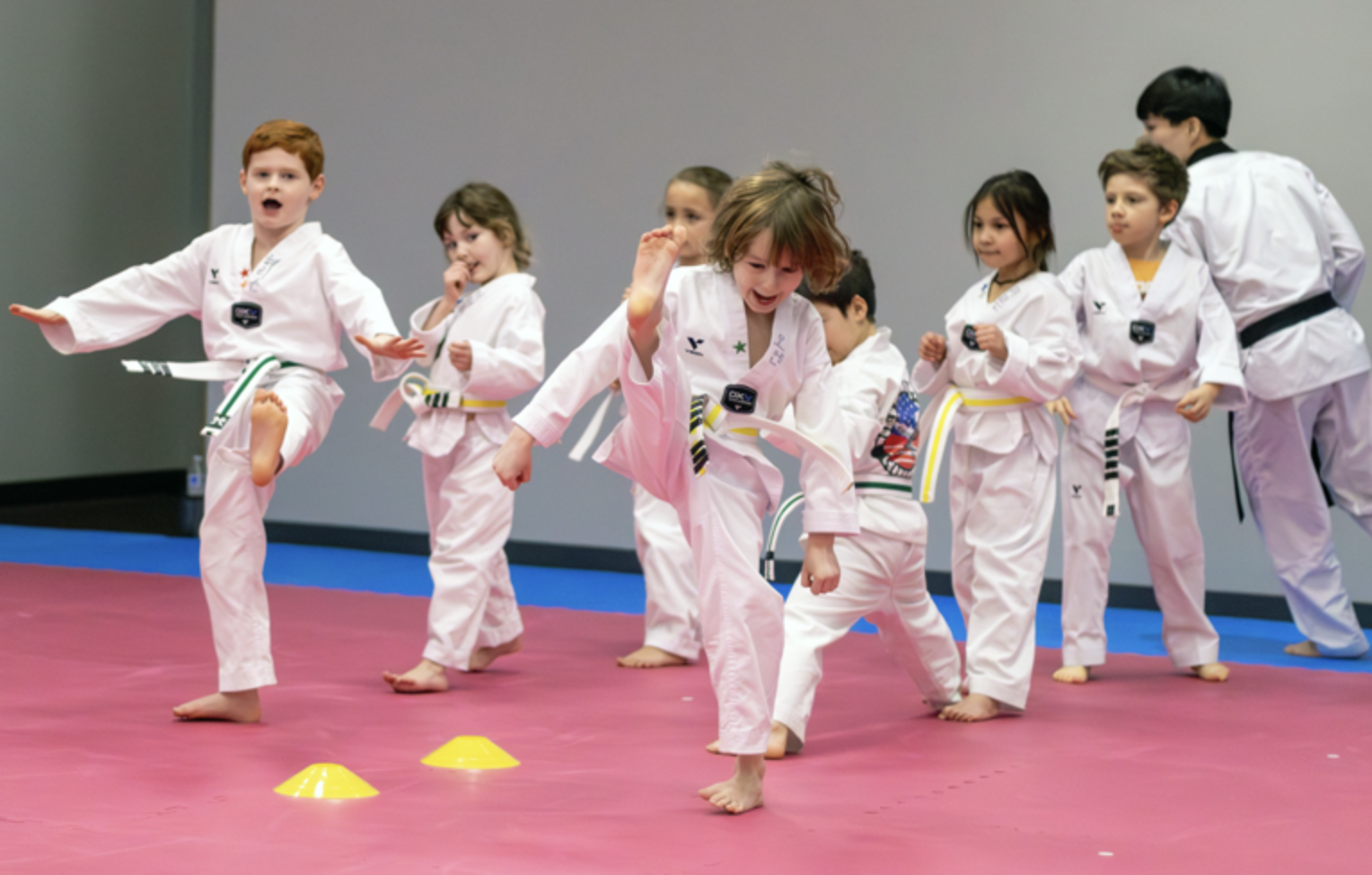 Kids practicing kicks in class