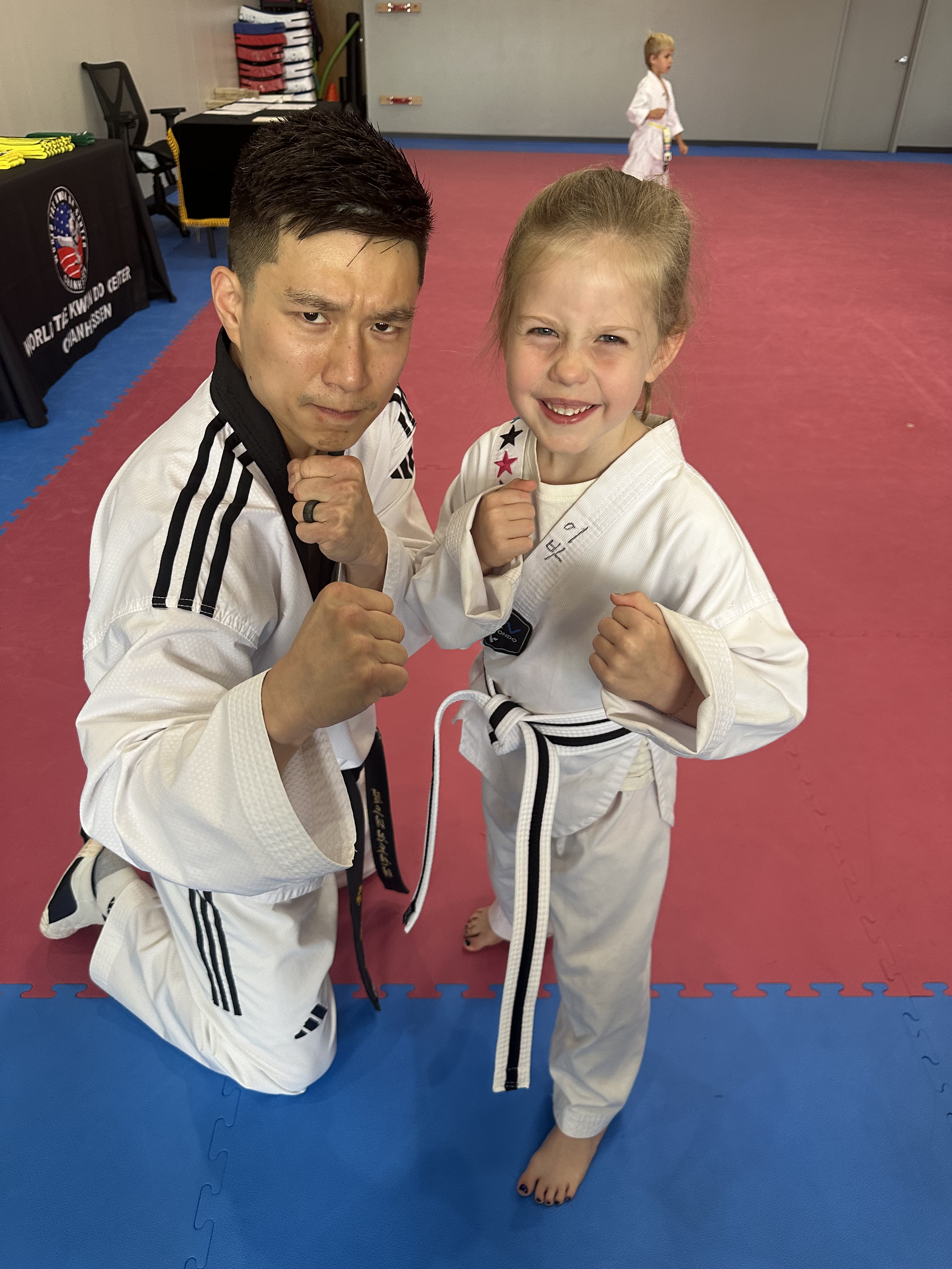 Instructor and young student in fighting stance