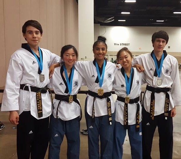 Adult students practicing Taekwondo techniques