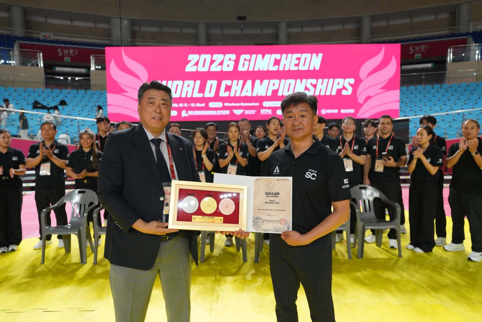 Grandmaster Kwangil Bae receiving the Best Referee award
