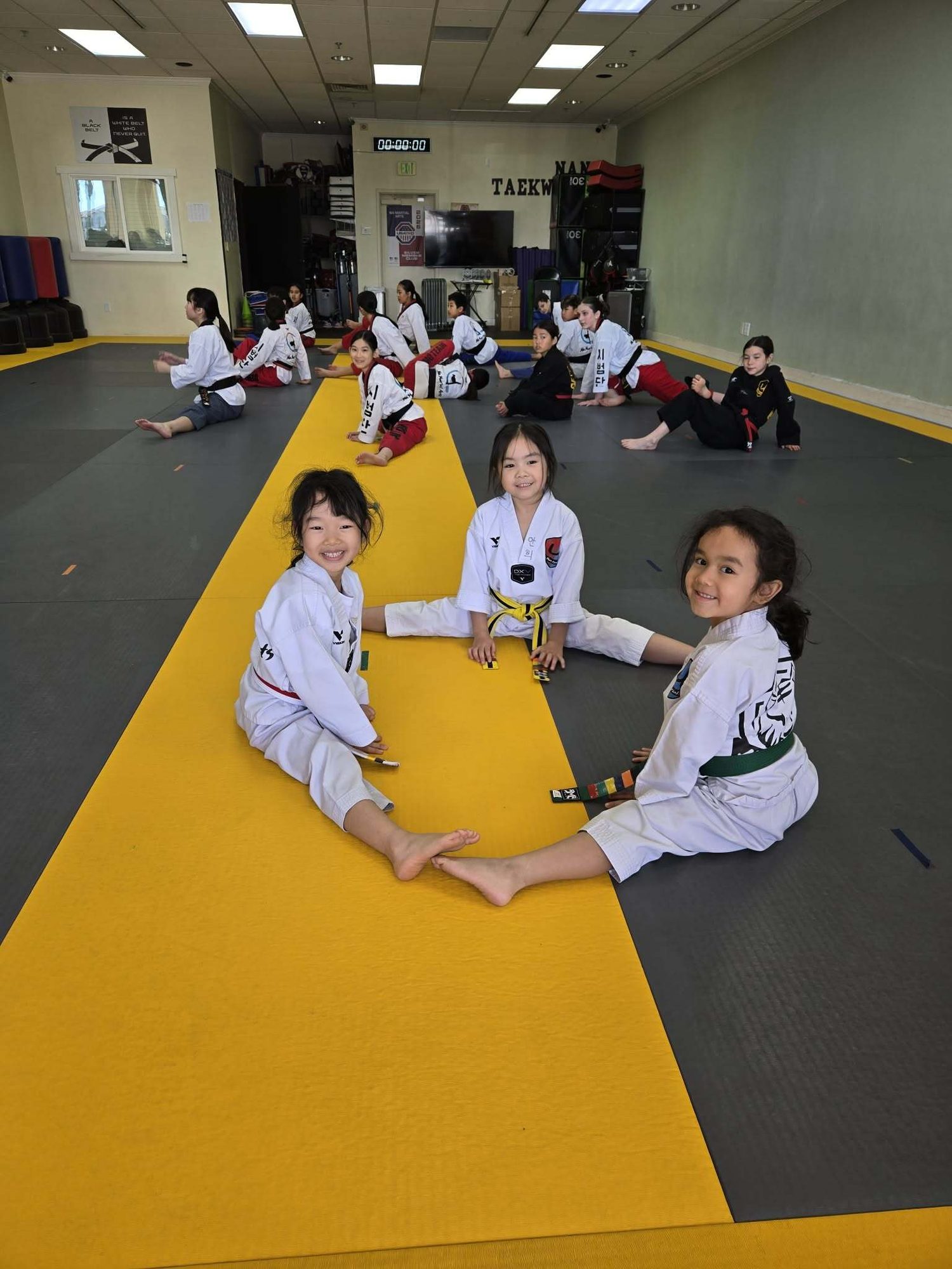 Students stretching together on the mat