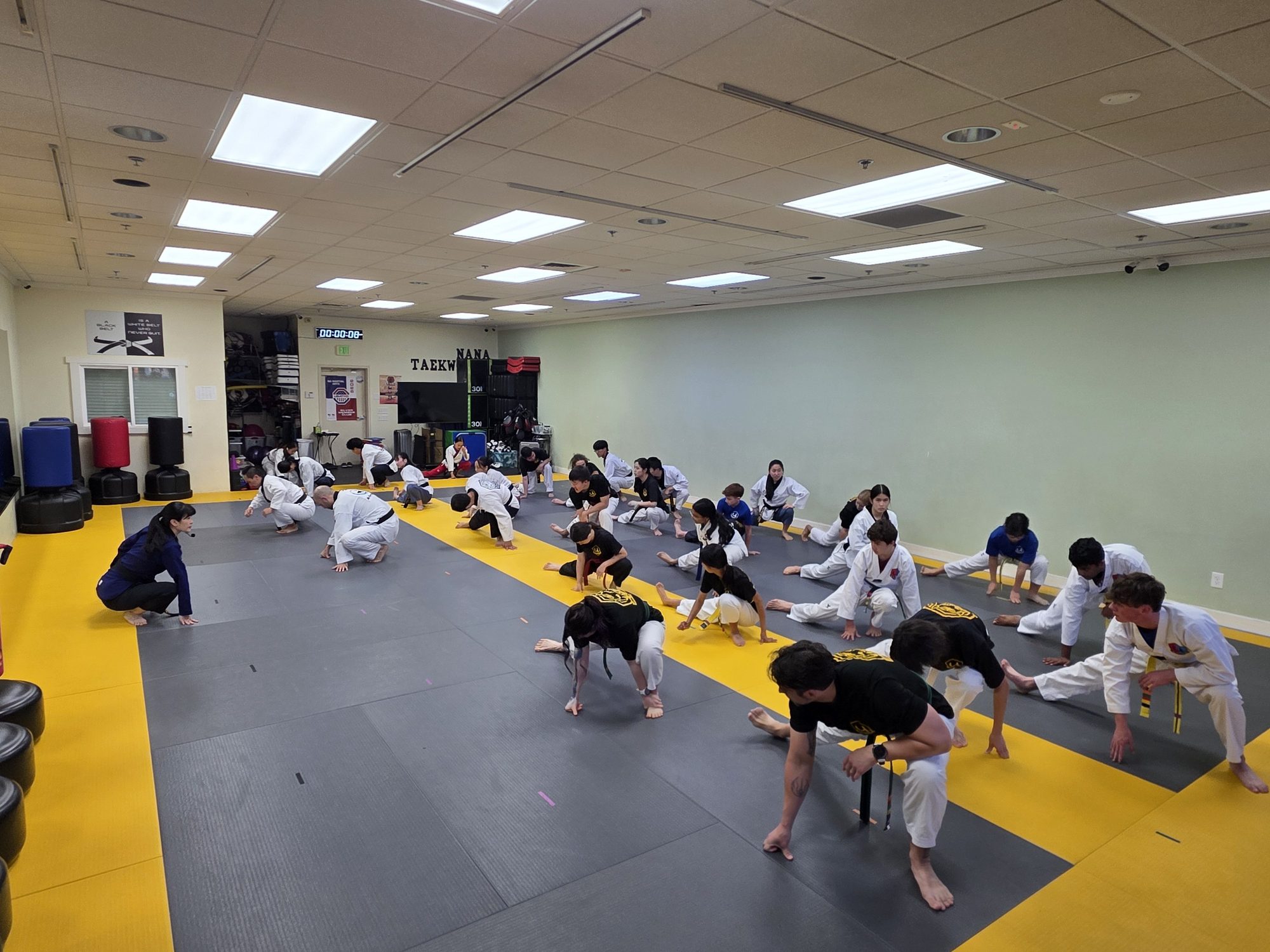 Class doing floor exercises during warm-up