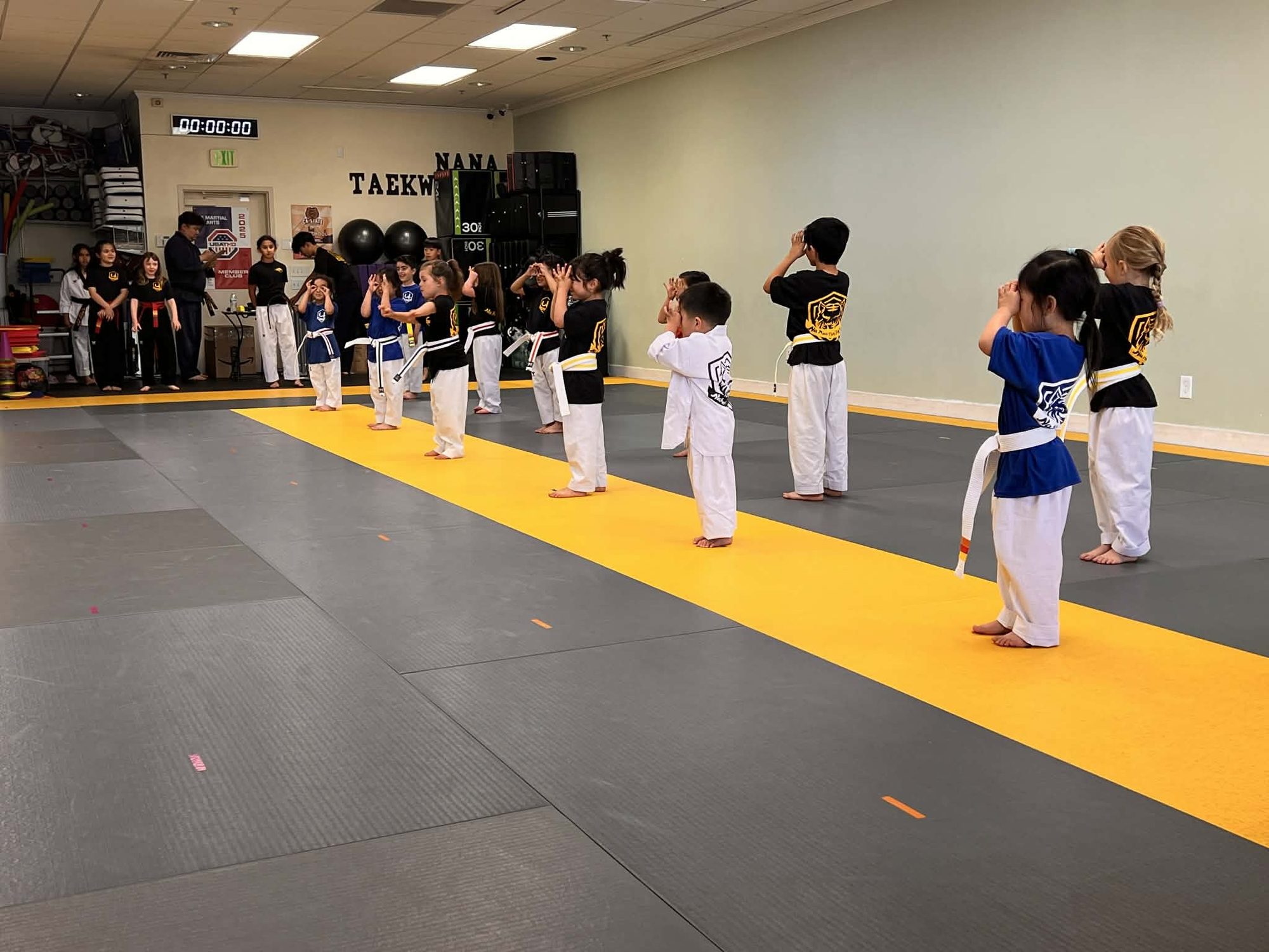 Little students lined up for kicking drills