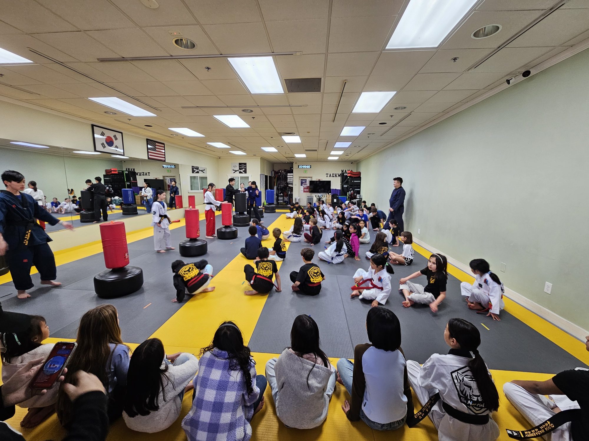 Families watching a special event at the dojang