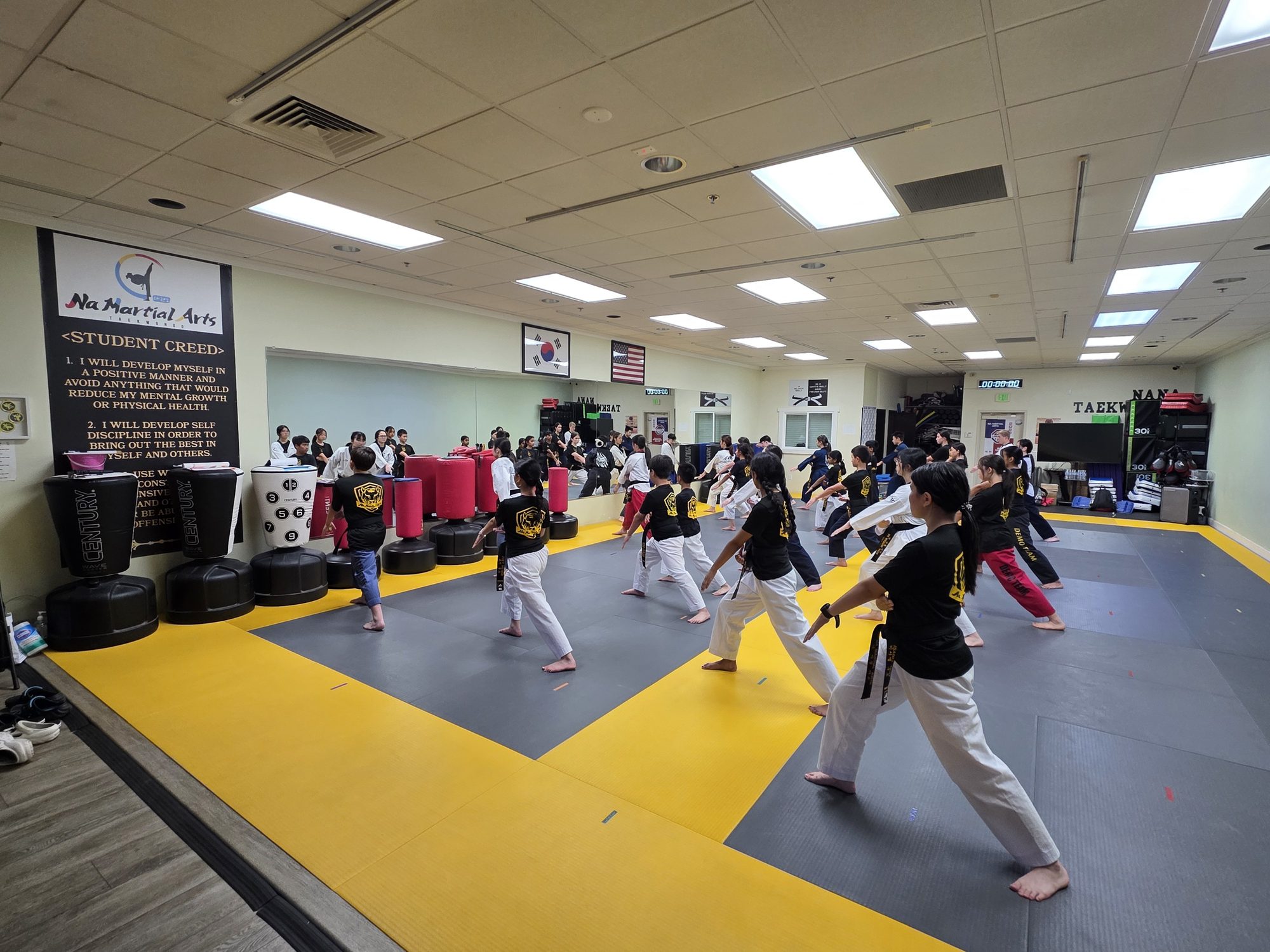 Students practicing techniques on the training floor