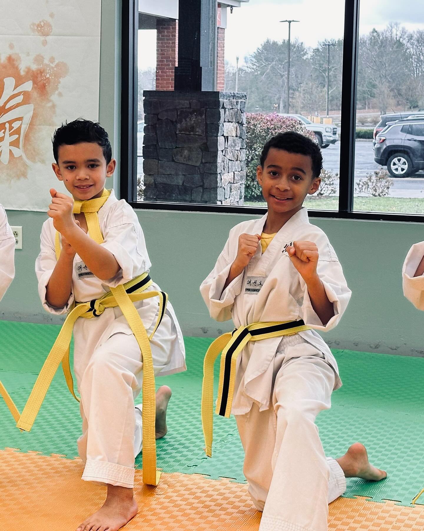 Two young Little Tigers students practicing stances together in class
