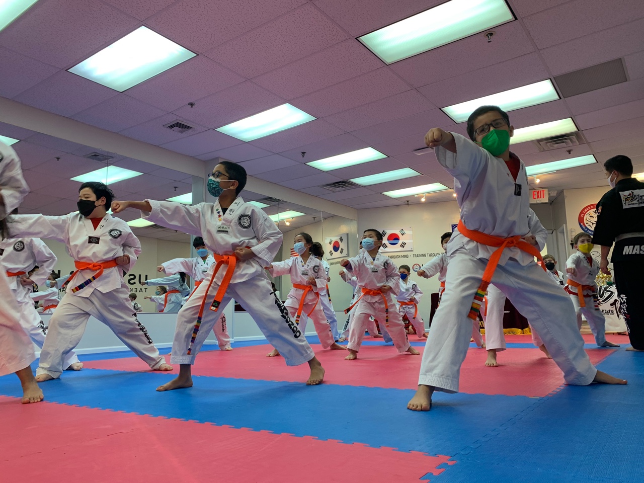 Children progressing through belt ranks in Taekwondo