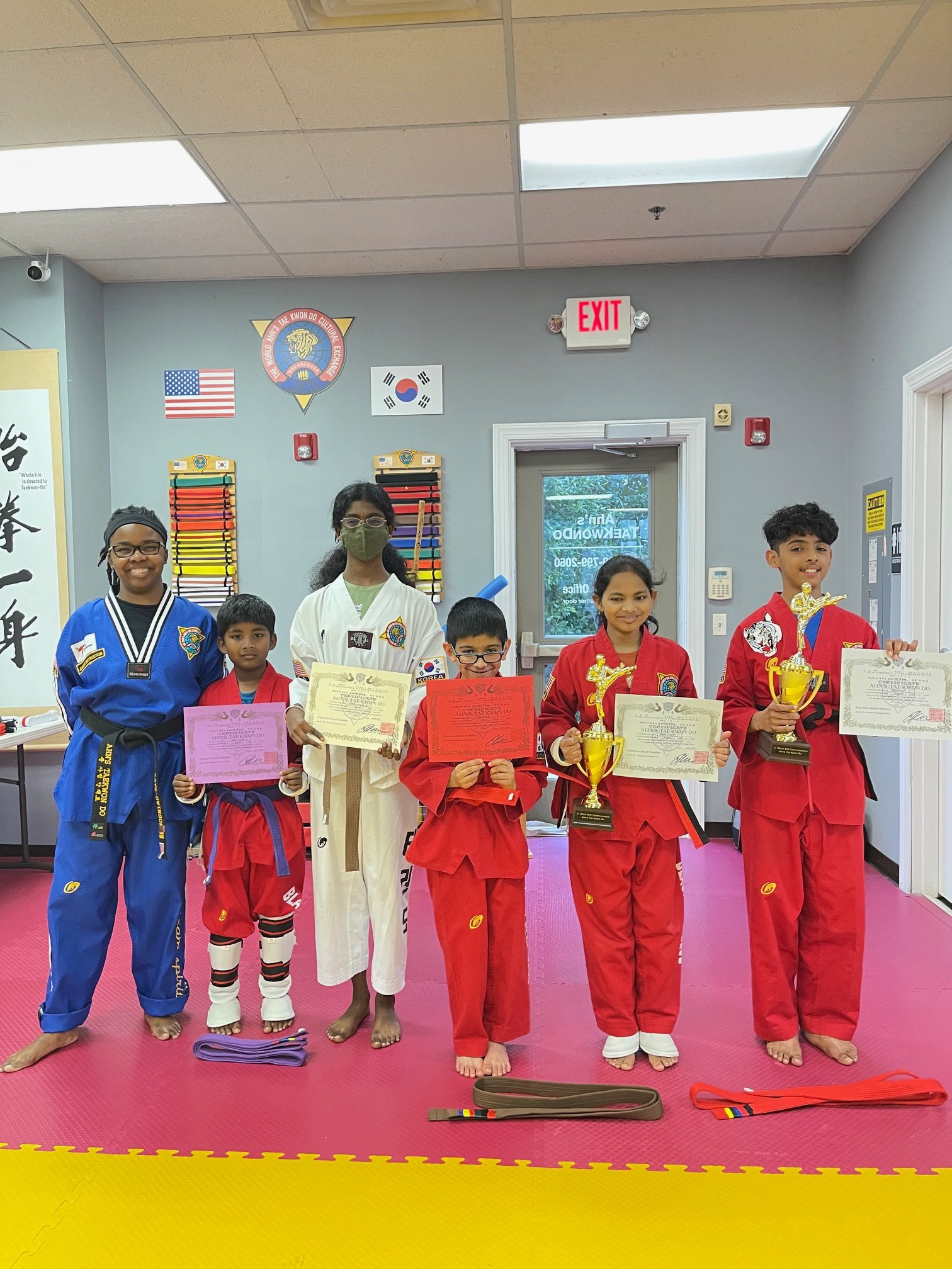 Young students receiving awards and certificates at the dojang