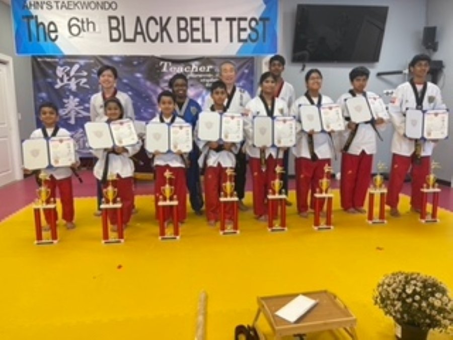 Students lined up on stage at the 6th Black Belt Test at Ahn's Taekwondo