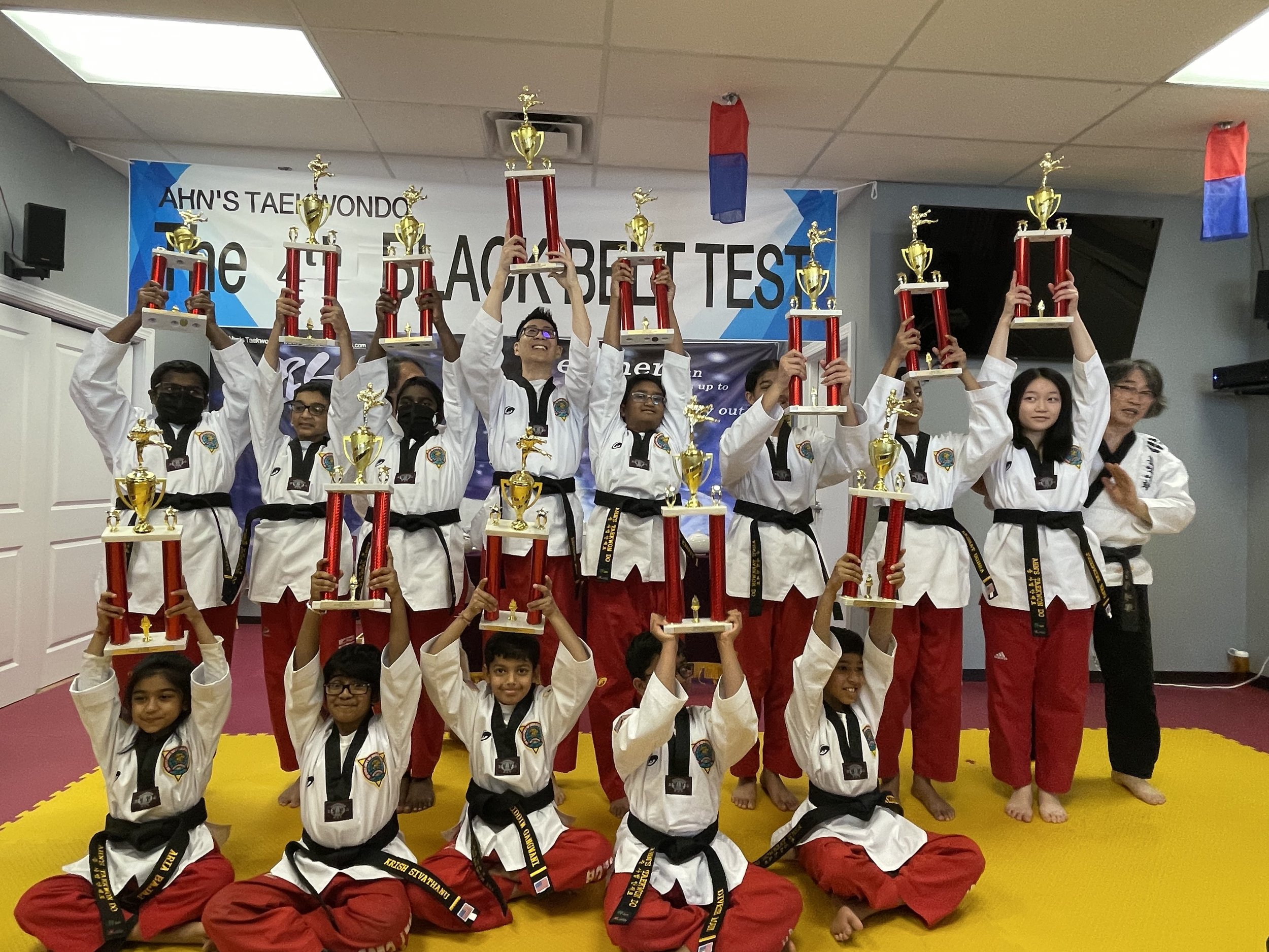 Black belt test candidates with their trophies after testing