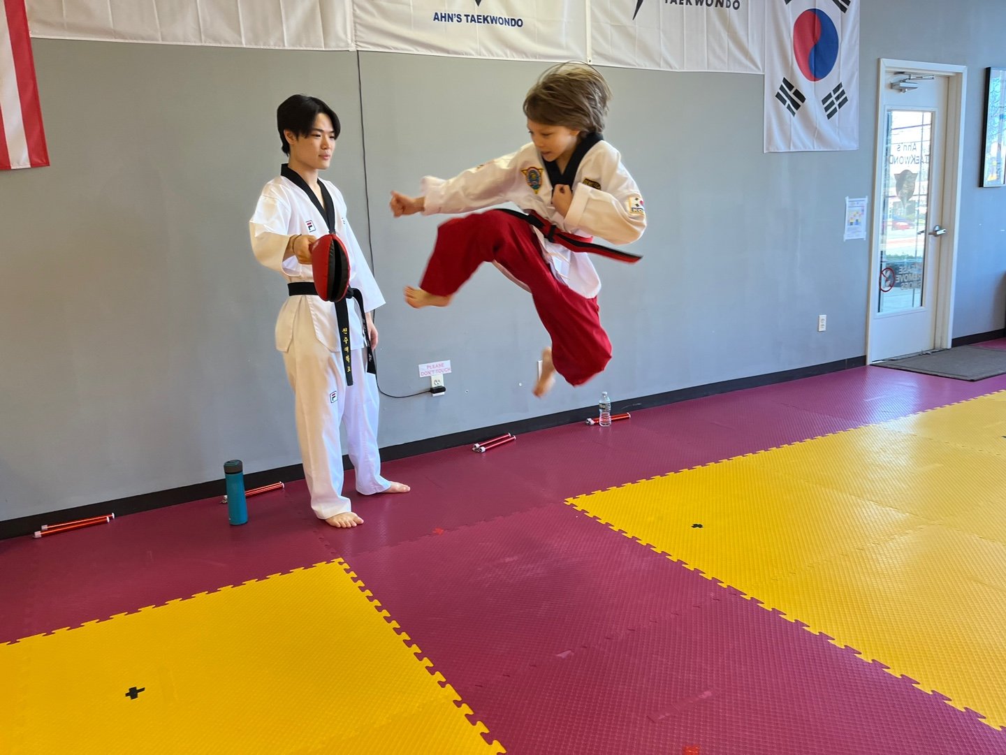 DEMO Team performing a jumping kick at Ahn's Taekwondo