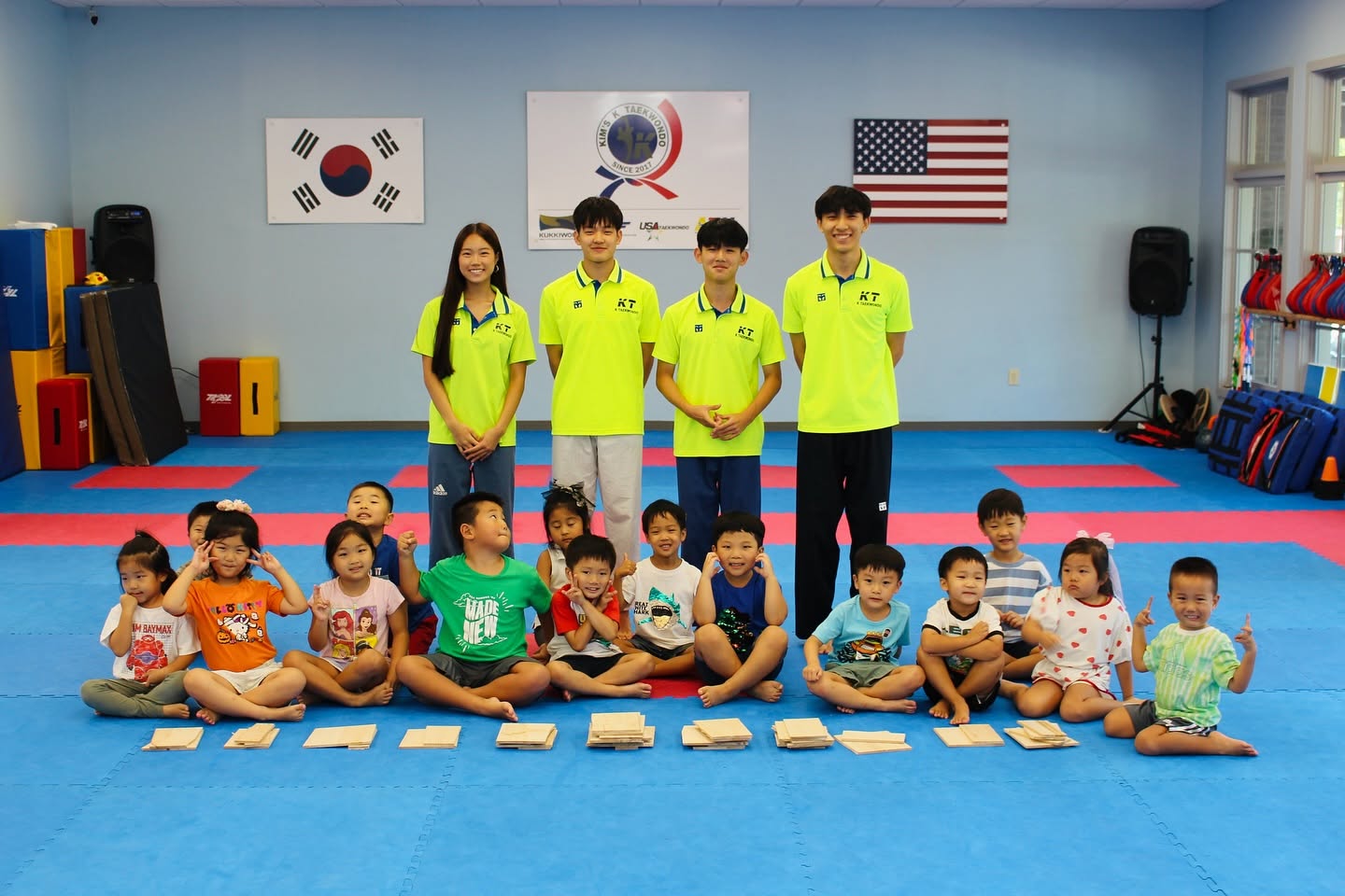 Camp counselors and young campers together after a board breaking session