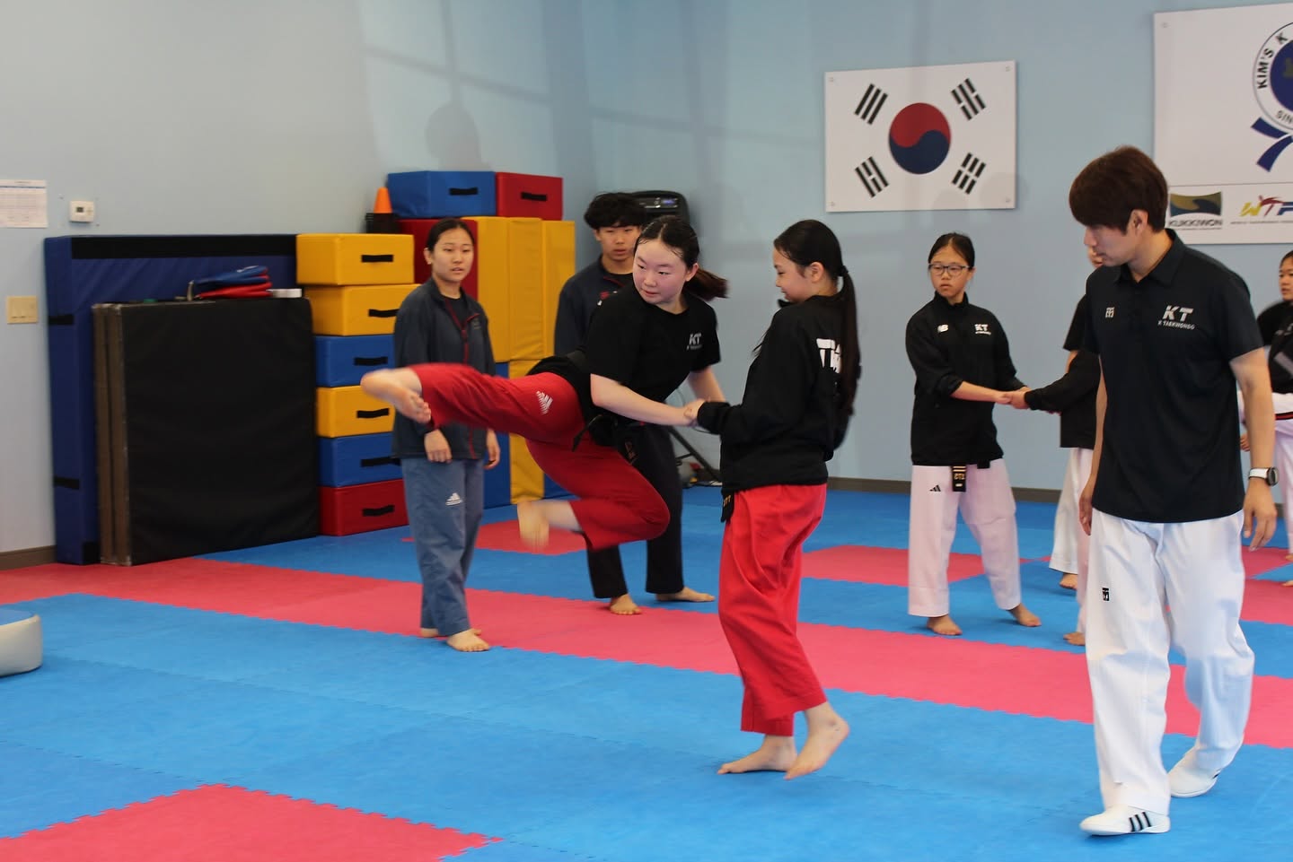 Instructor correcting a student's kick during focused training