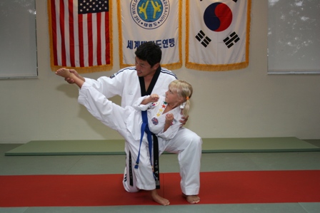 Grandmaster Dae Hoon Lee teaching a young student in Sarasota