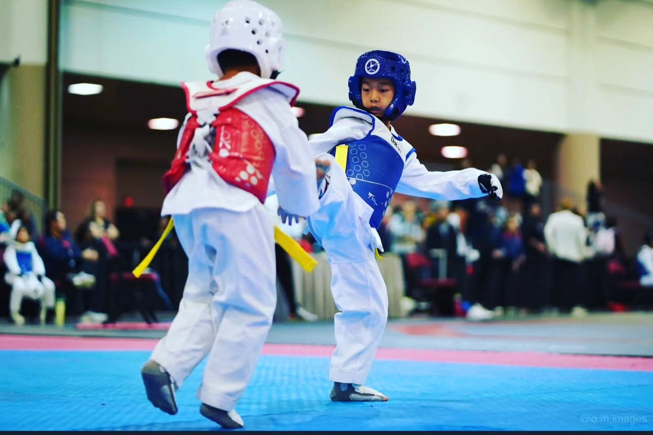 JK Taekwondo athlete landing a kick in a sparring match