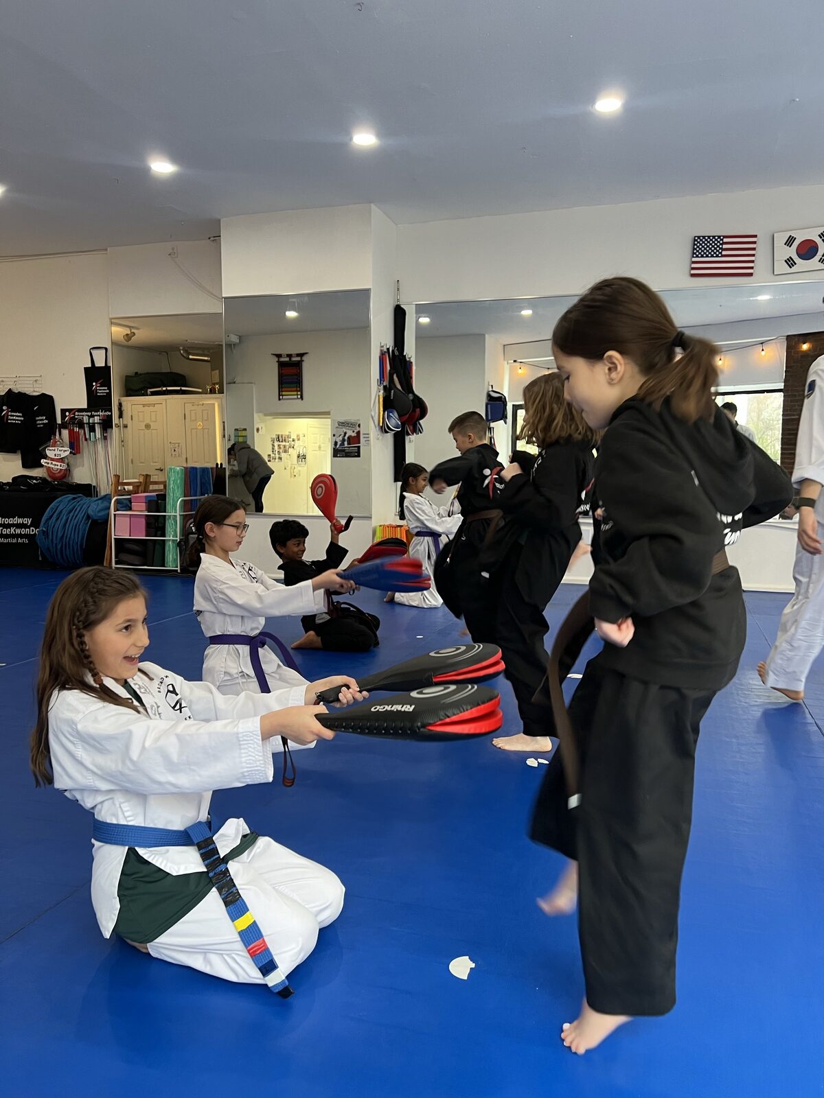 Students practicing kicking drills in pairs