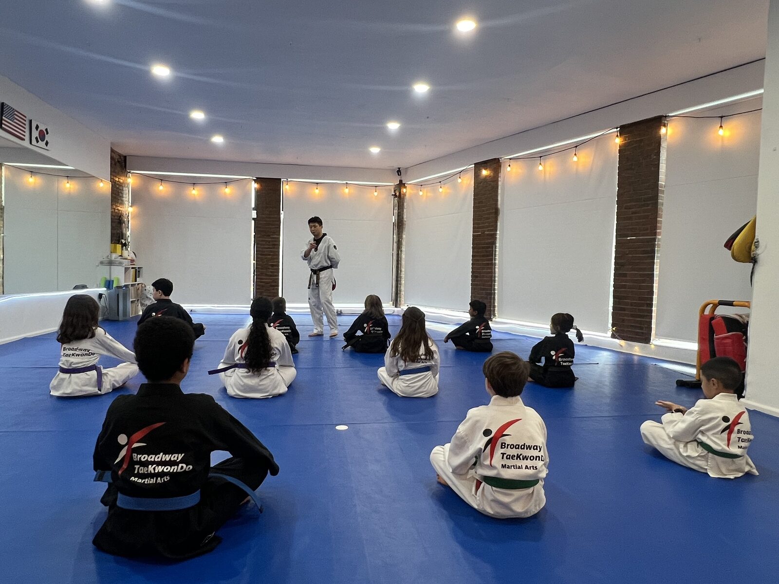 Junior class listening to their instructor on the mat