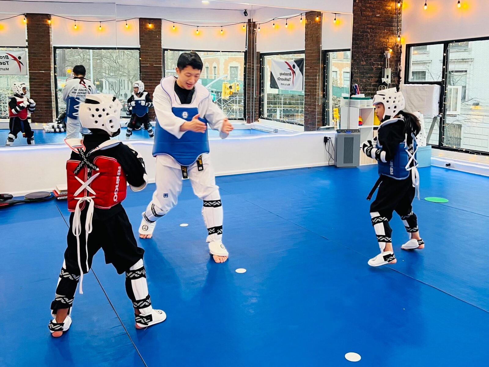 Junior students sparring with full protective gear