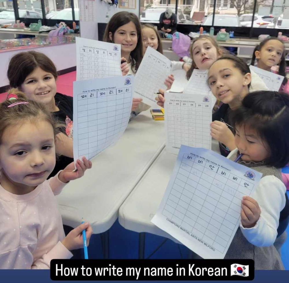 Little Tigers students learning to write their names in Korean