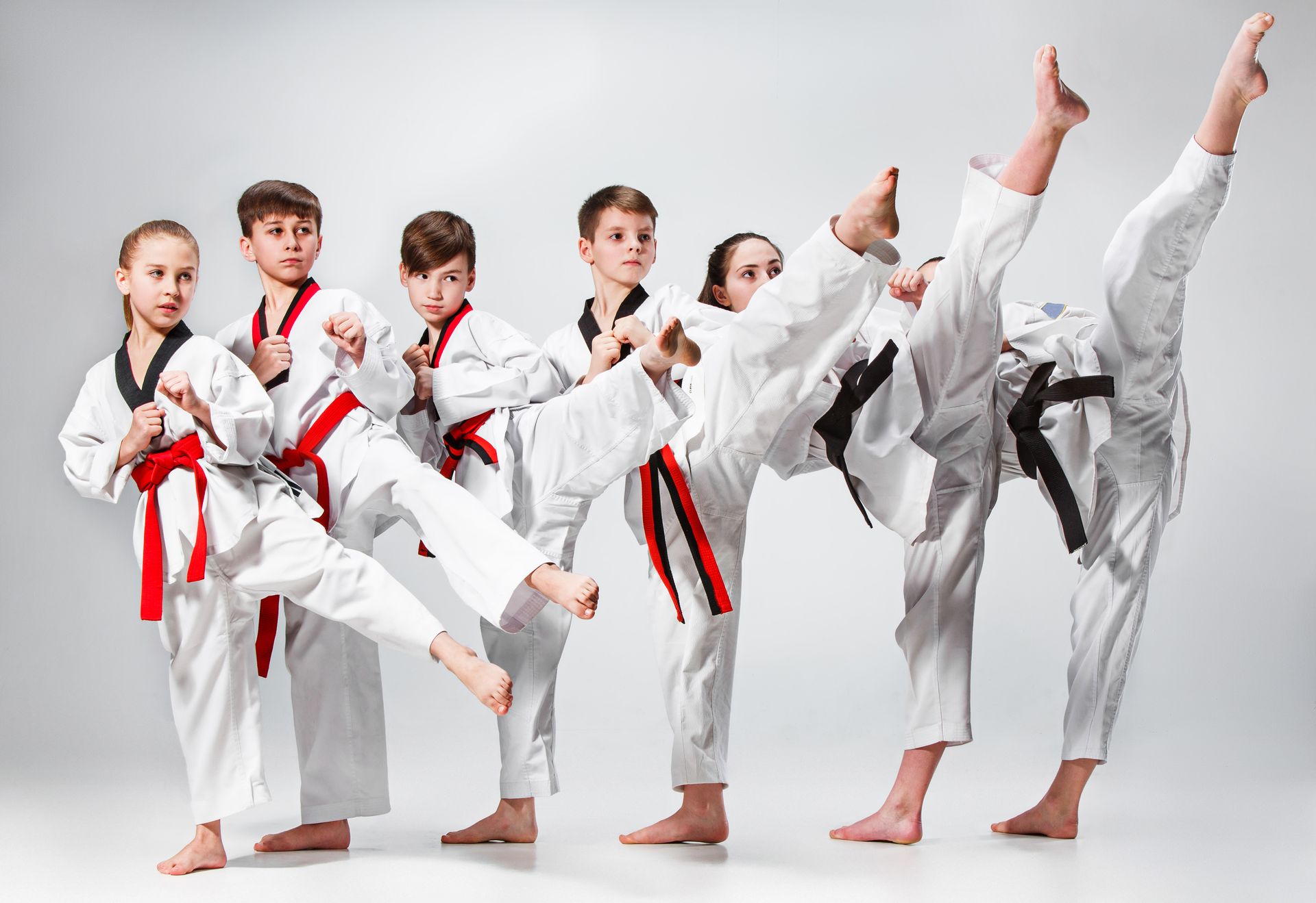Kids performing Taekwondo kicks together