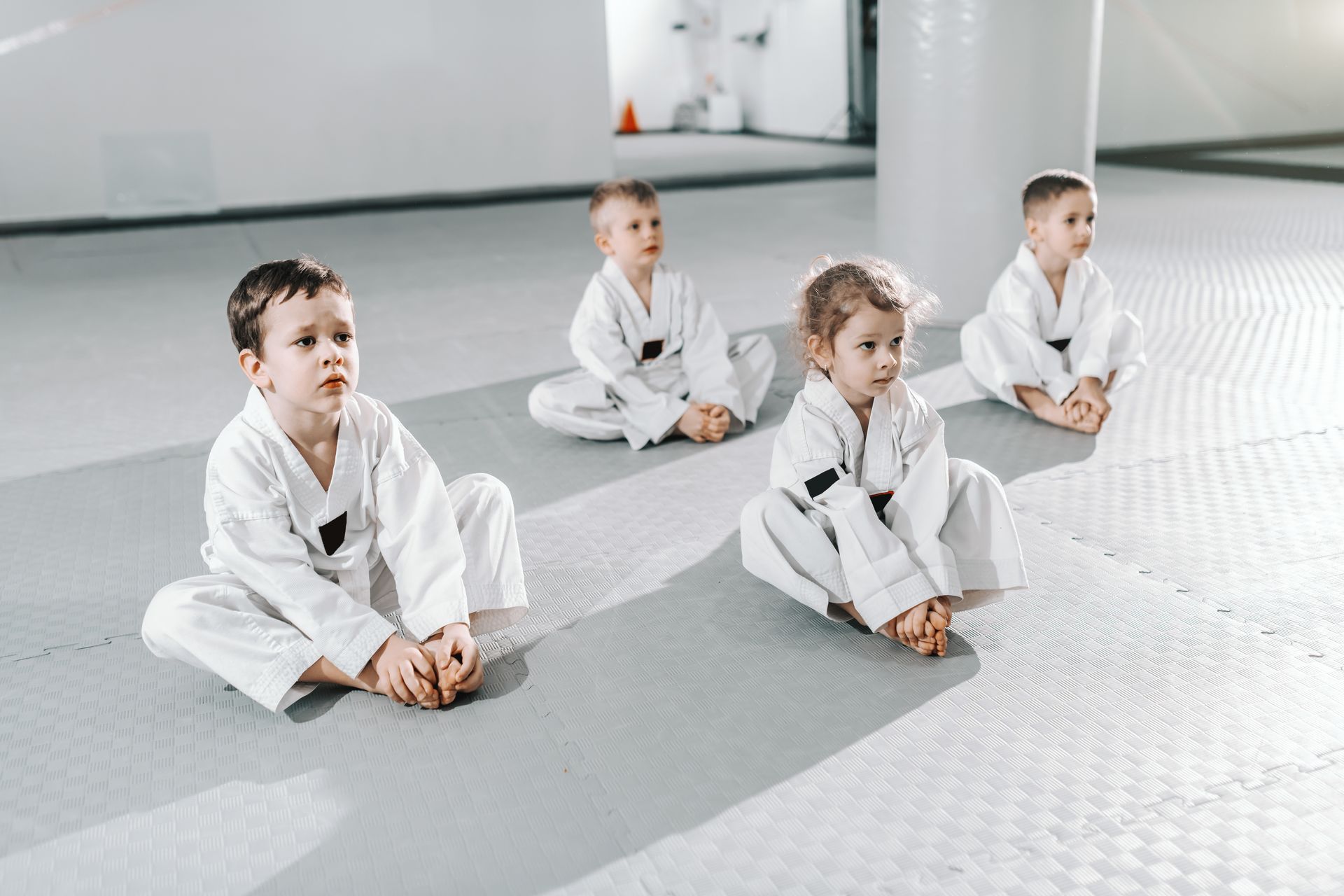 Young students sitting together on the mat
